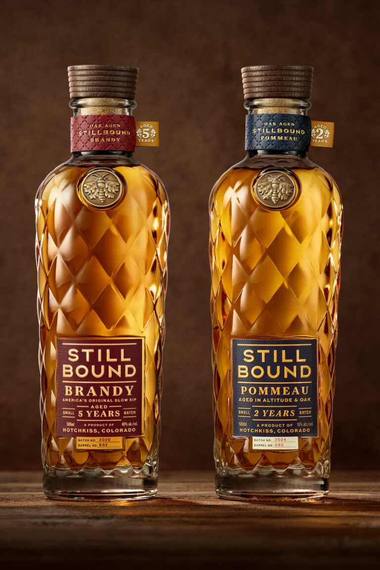 Stillbound premium brandy and pommeau branding and package design featuring a bespoke bottle, custom closure, oak moth emblem, and quilted glass inspired by mountain heritage and outdoor ritual.