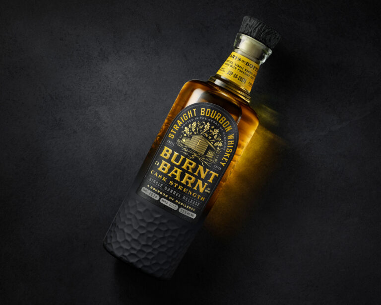 Burnt Barn Bourbon custom bottle and packaging design featuring sculpted glass, matte black decoration, and a faux wood-grain closure.